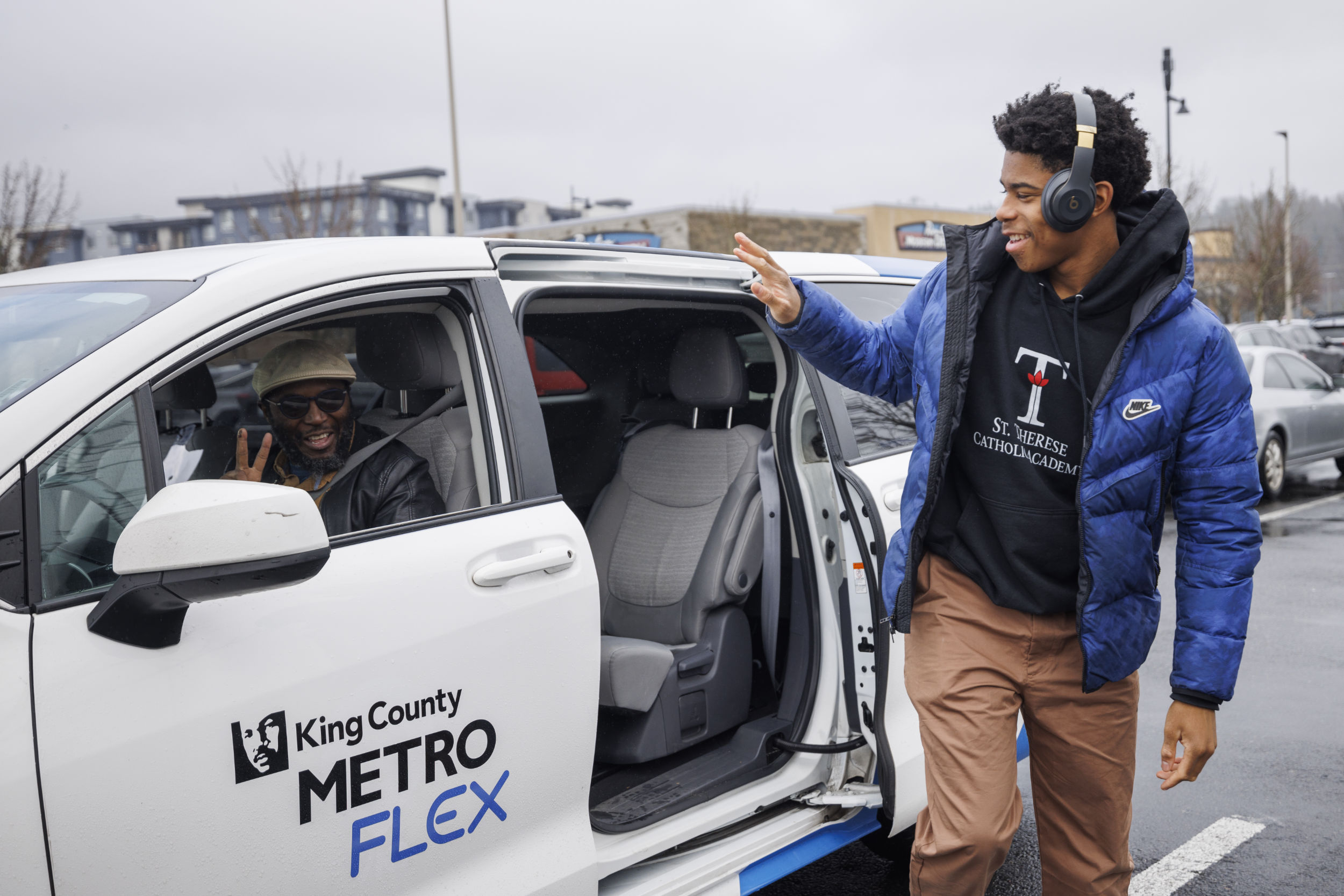 Metro Flex passenger waves goodbye to the friendly driver after exiting the white King County Metro Flex van