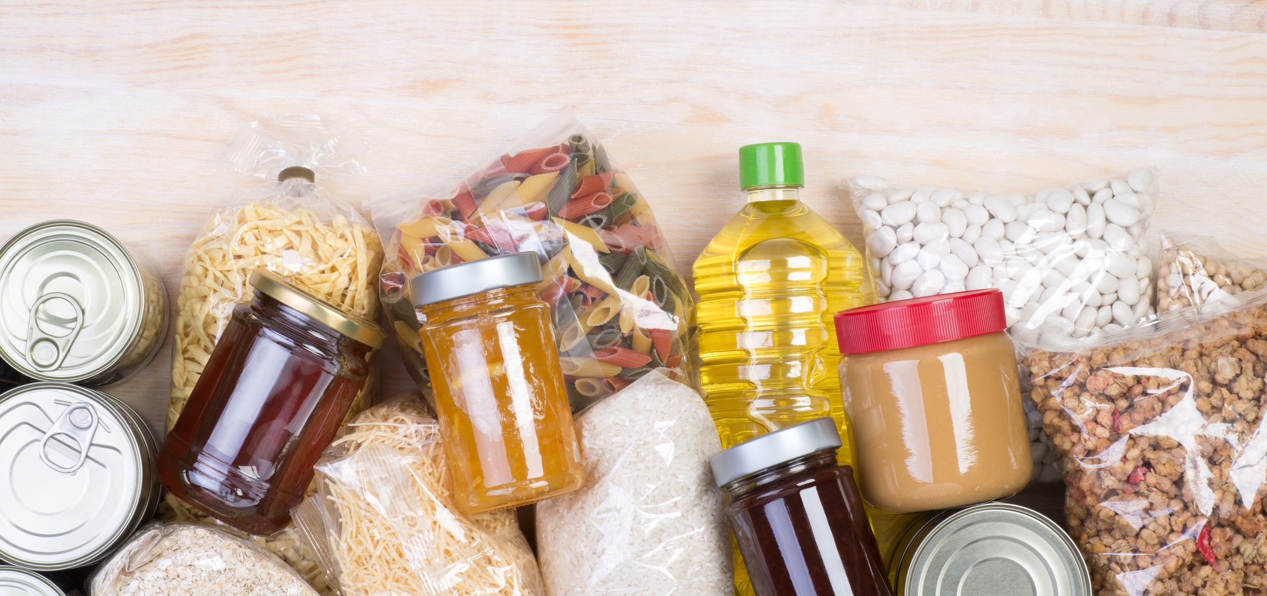 Nonperishable food items such as: jars of jelly, jam, honey, and peanut butter; bags of pasta, noodles, grains, beans; and canned food items.