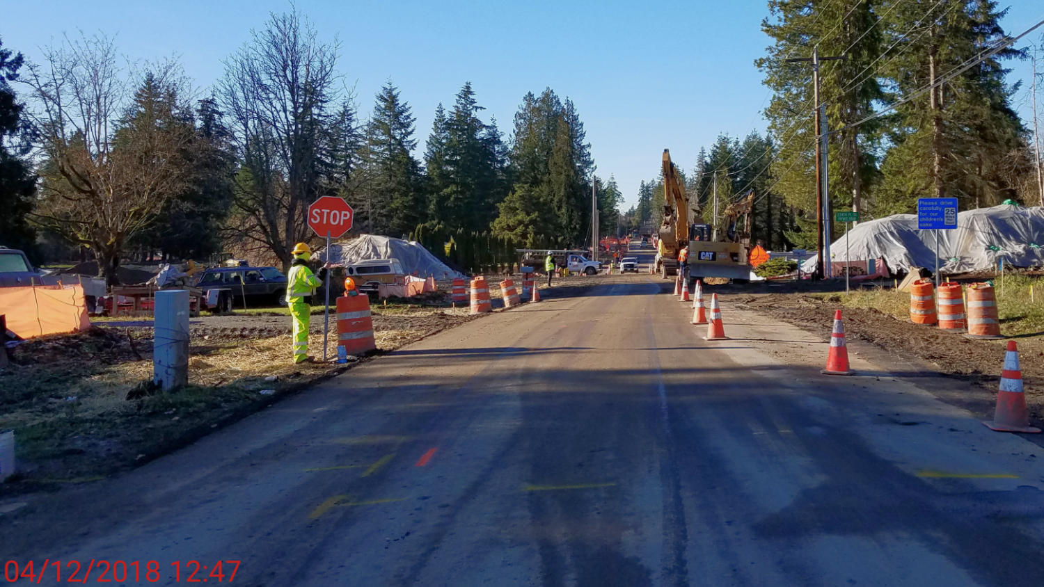 flaggers directing traffic during the watermain install