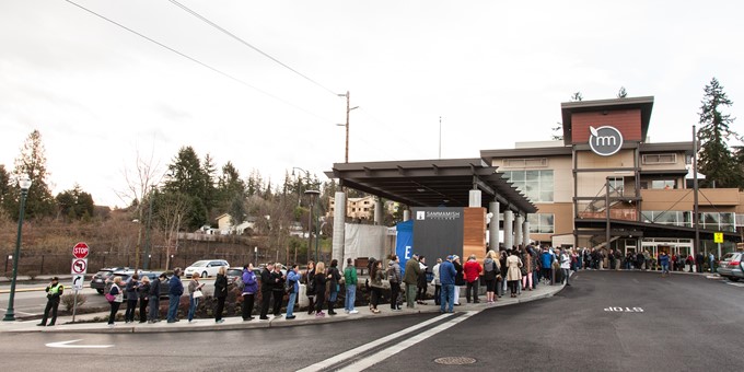 queue to enter the Metropolitan Market curves along the sidewalk to the exit of the parking lot