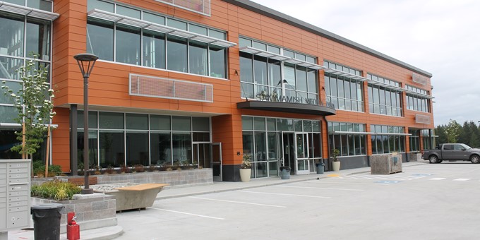 rendering of Sammamish Medical Pavilion, showing a wide orange two-story building with lots of windows