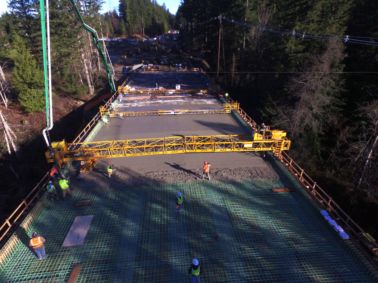 deck of the bridge on Issaquah Fall City Road being poured with concrete, about halfway complete