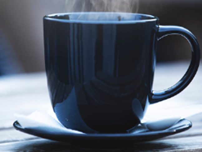 Dark blue coffee mug with steam rising from it.