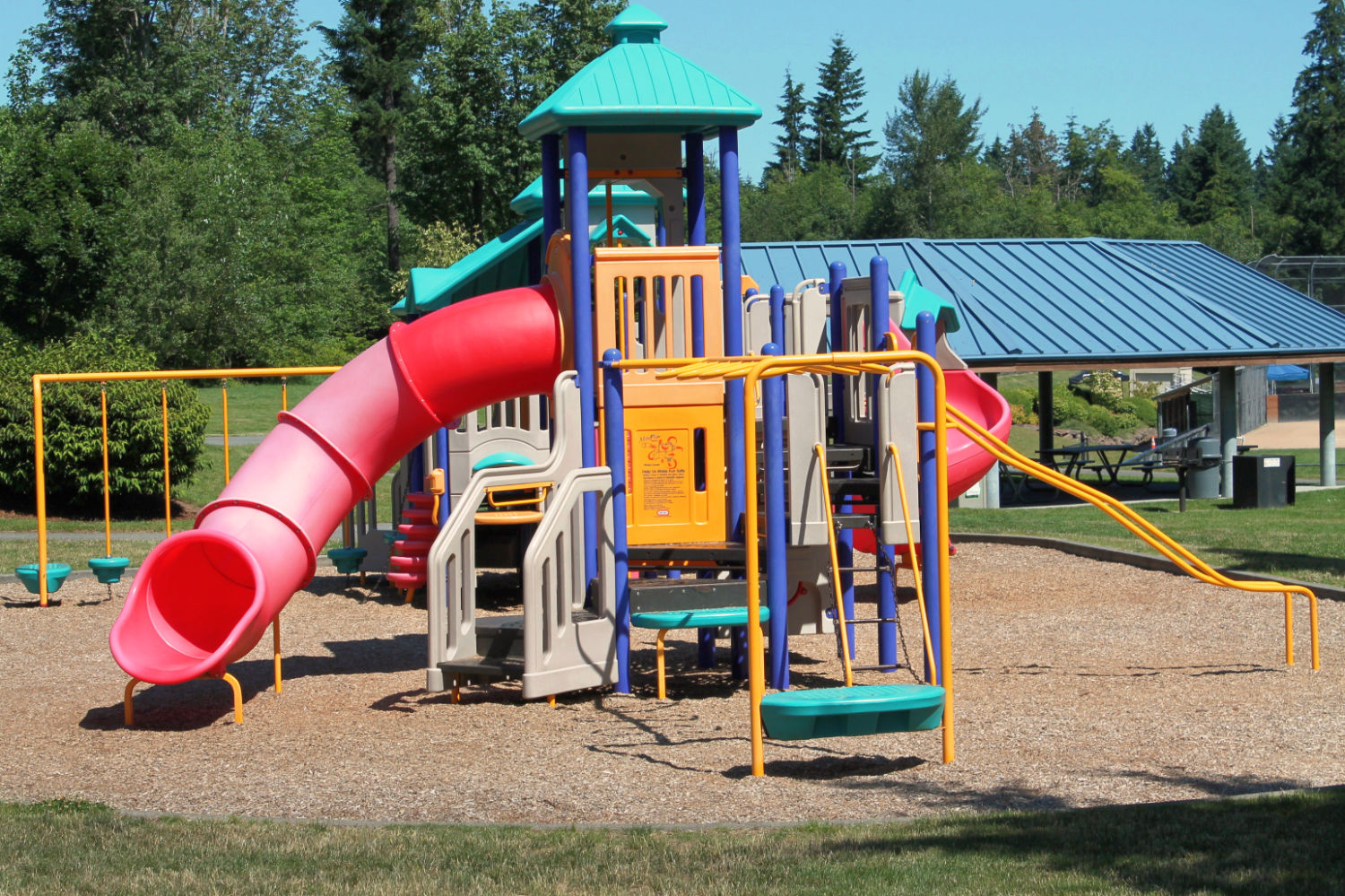 East Sammamish Park playground structure with slides, ladders, climbing apparatuses, and other attachments.