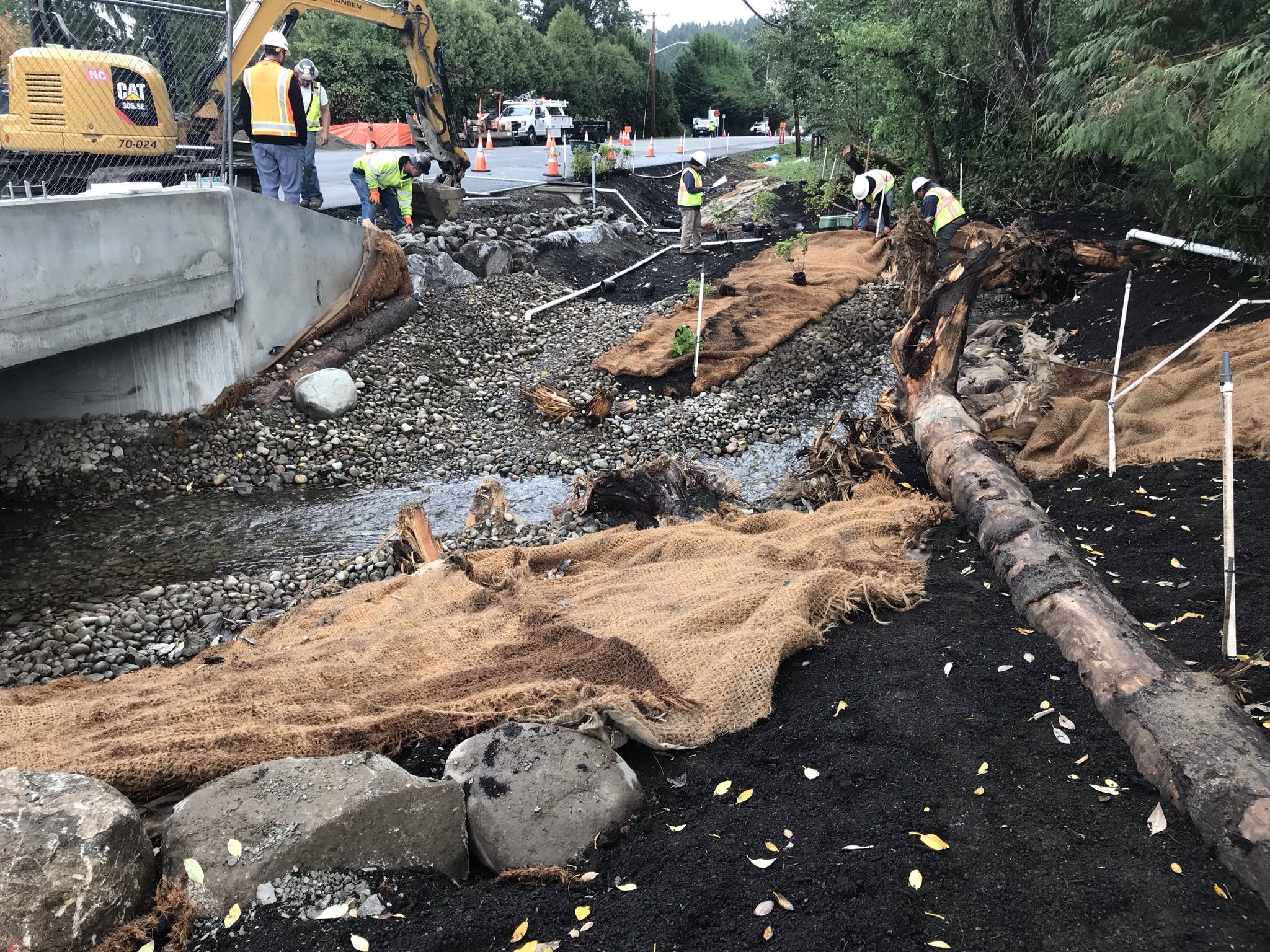 Six crew members work on the upstream restoration and creek realignment on the Ebright Creek Fish Passage Project.