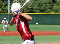 Pitcher throws baseball and batter is ready to take a swing at baseball field at Eastlake Community Fields.