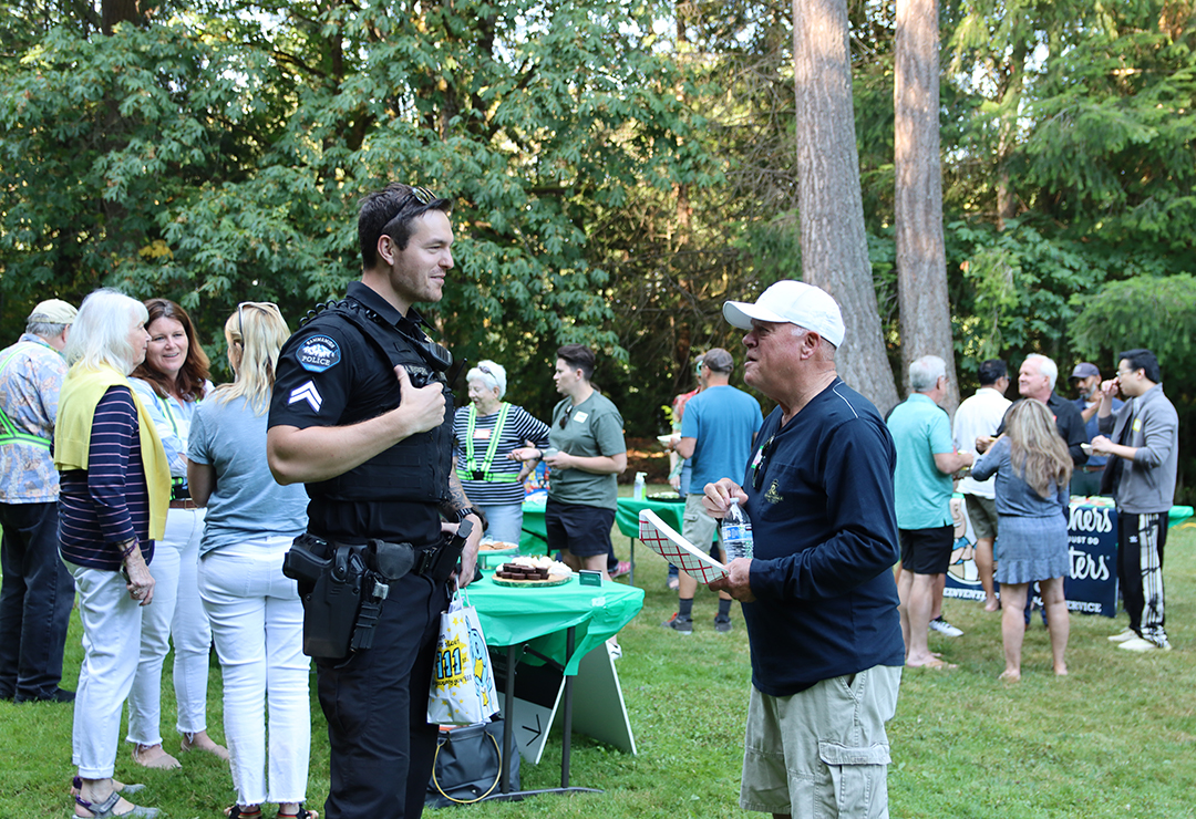Sammamish police officer with a member of the public at an outdoor event