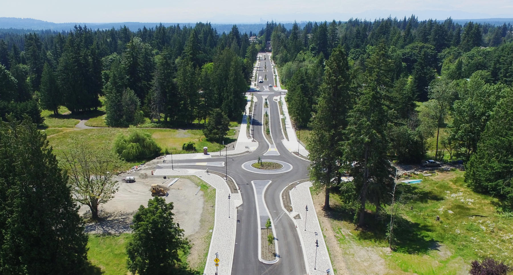 photo of redeveloped 4th Street, showing islands dividing road lanes and two roundabouts