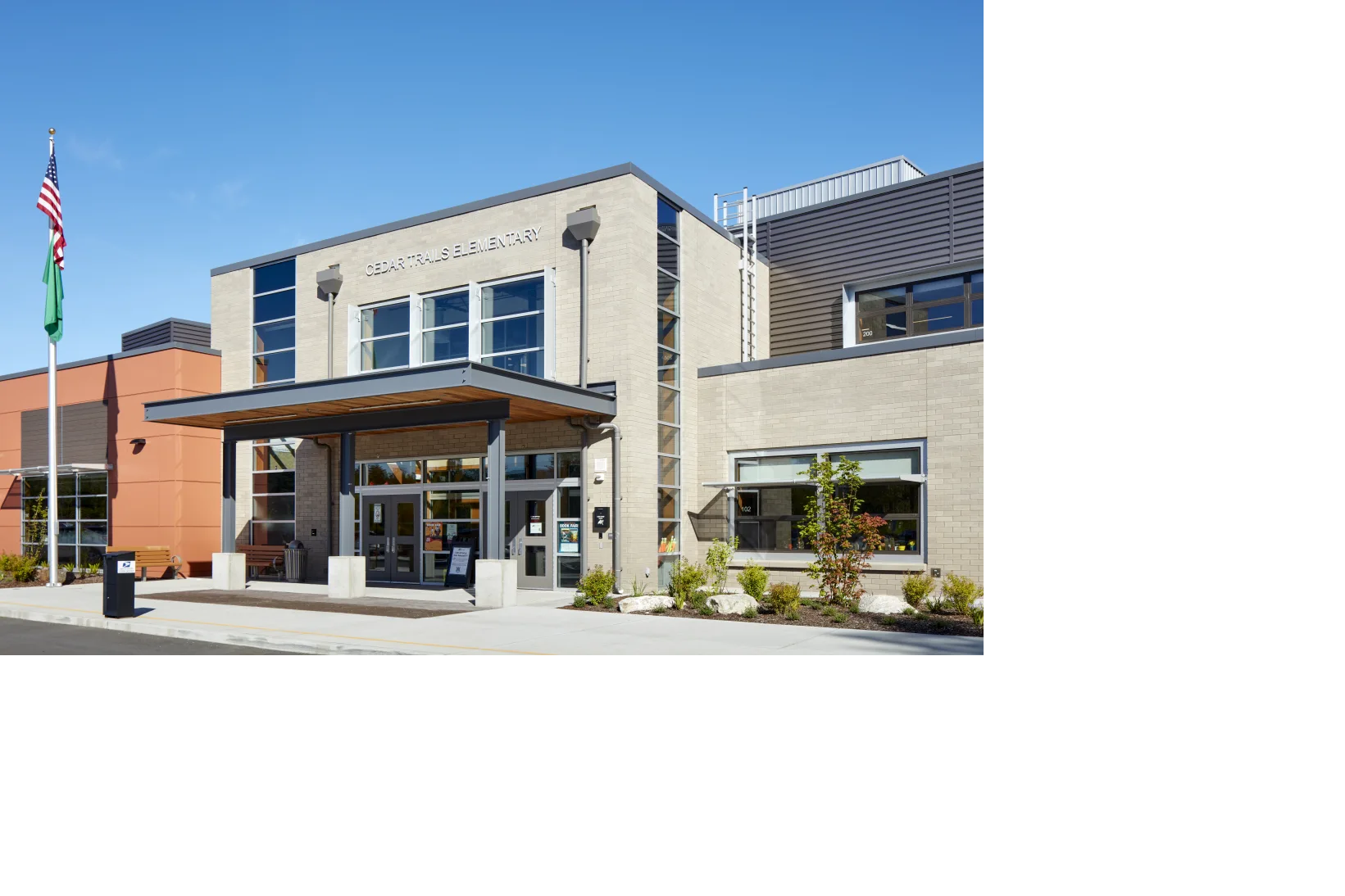 photo of entrance to Cedar Trails Elementary School, a covered awning providing shelter over the doors into the modern style building