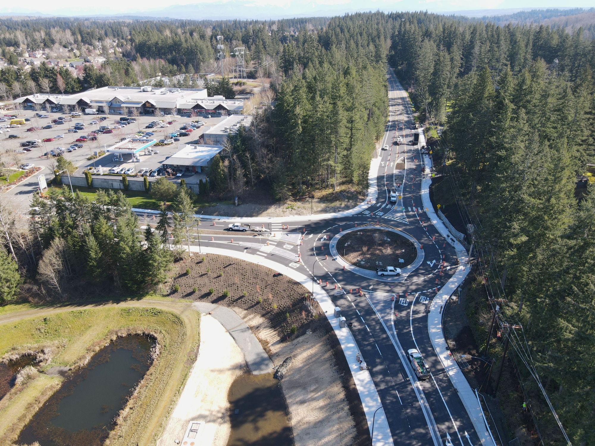oblique aerial of constructed roundabout on Issaquah Fall City Road next to the QFC, with three entrance and exit points 