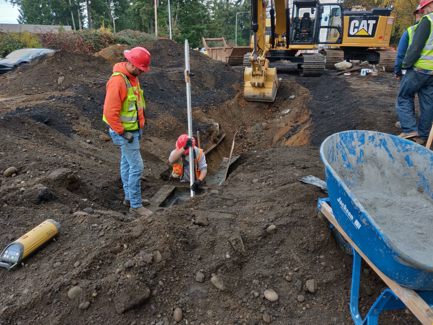 workers inspecting progress of excavation at Issaquah Fall City Road construction